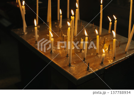 Burning candles in an old church. Selective focus. Burning candles in an old church. Selective focus. 137788934