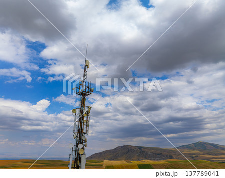 Telecommunications tower in rural landscape under cloudy sky Telecommunications tower in rural landscape under cloudy sky 137789041