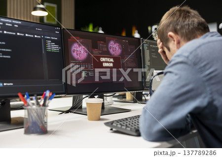 Engineer in startup office doing facepalm, worried after struggling to fix application errors while coding. Distressed IT worker troubled by computer bugs while coding in software development agency Engineer in startup office doing facepalm, worried after struggling to fix application errors while coding. Distressed IT worker troubled by computer bugs while coding in software development agency 137789286