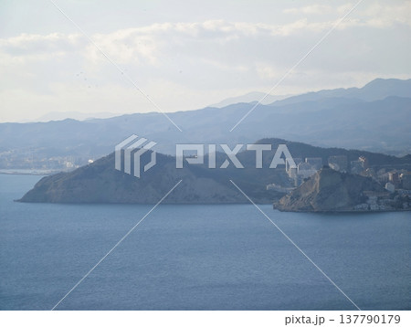 Calm Sea Surrounds Historic Isle, Serene Maritime Landscape With Heritage Site And Rugged Cliffs 137790179