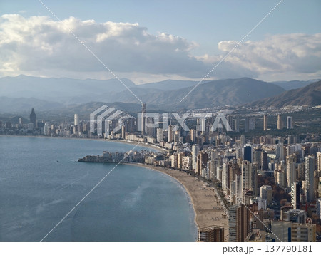 Dramatic Cloudy Horizon With Towering Buildings And Scenic Mountain Backdrop For Storytelling Dramatic Cloudy Horizon With Towering Buildings And Scenic Mountain Backdrop For Storytelling 137790181