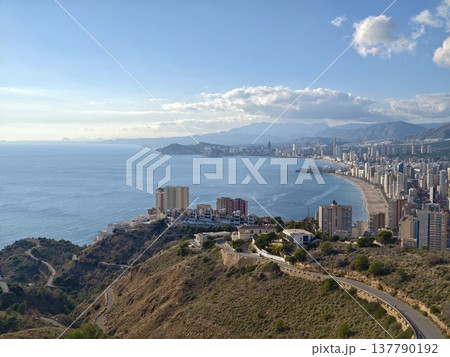 Serene Shoreline City Vista Featuring Highrise Buildings And Tranquil Sea Under Soft Cloud Cover Serene Shoreline City Vista Featuring Highrise Buildings And Tranquil Sea Under Soft Cloud Cover 137790192