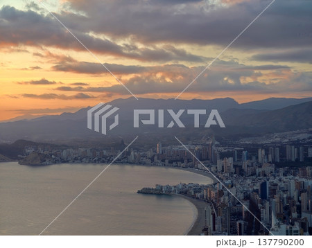 Tranquil Shoreline With Distant Mountains, Peaceful Morning Overlooking Beach And Gentle Sea Tranquil Shoreline With Distant Mountains, Peaceful Morning Overlooking Beach And Gentle Sea 137790200