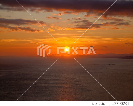 Sun Sets Peacefully, Beautiful Dusk Scene Showing Sun Disappearing Over Peaceful Waters And Distant Islands 137790201