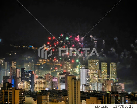 Nighttime Celebration With Sparkling Lights, Vibrant City Skyline Illuminated By Fireworks And Festivities 137790329