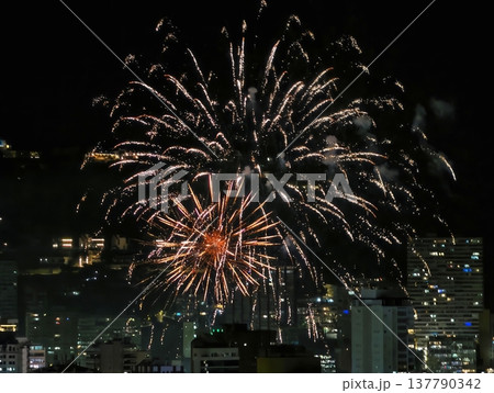 Colorful Explosion Illuminates Urban Skyline, Radiant Orange Burst Lights Up Night Sky Scene Colorful Explosion Illuminates Urban Skyline, Radiant Orange Burst Lights Up Night Sky Scene 137790342
