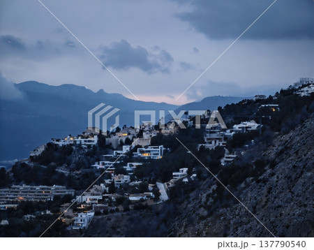 Remote Mountain Settlement At Dusk, Tranquil Settlement Perched Amidst Rugged Rocks And Drifting Clouds Remote Mountain Settlement At Dusk, Tranquil Settlement Perched Amidst Rugged Rocks And Drifting Clouds 137790540