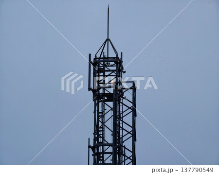 Quiet Industrial Tower Silhouette, Lonesome Steel Structure Against Peaceful Horizon With Muted Colors Quiet Industrial Tower Silhouette, Lonesome Steel Structure Against Peaceful Horizon With Muted Colors 137790549