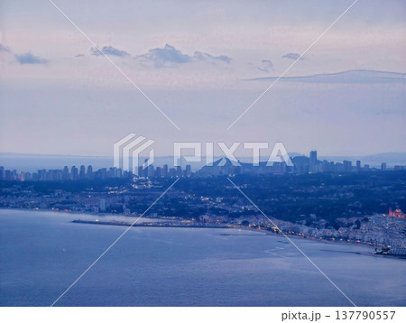 Harbor Nighttime Activity, Nighttime Industrial Port Scene With Cranes And Shimmering City Lights 137790557