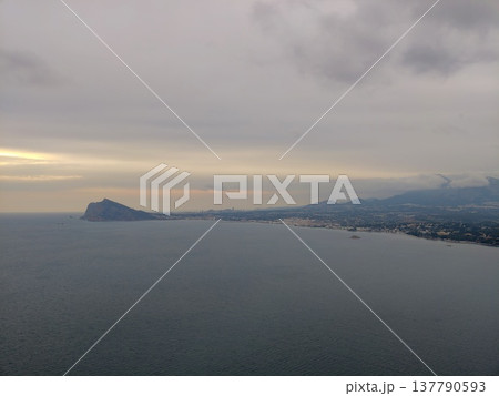 Peaceful Seaside Dawn, Early Morning Light Casting Calm And Soothing Atmosphere Across Quiet Shoreline 137790593