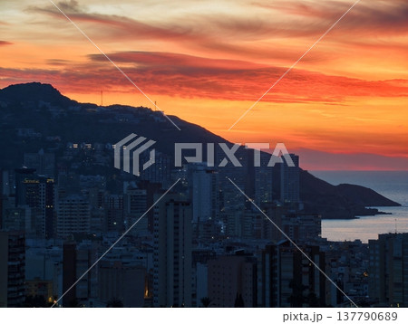 Vivid Cityscape Scene, City Skyline Illuminated By Sunset With Shimmering Windows And Towering Silhouettes 137790689