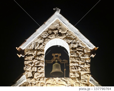 Bright Church Tower, Radiant Bell Tower Silhouette Sharply Contrasts With Dark Sky And Village Background Bright Church Tower, Radiant Bell Tower Silhouette Sharply Contrasts With Dark Sky And Village Background 137790764