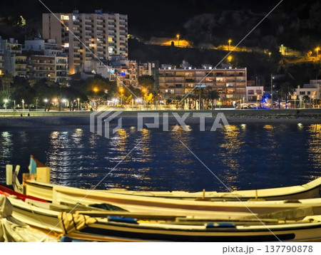 Serene Waterfront With Lights, Quiet Coastal Harbor Reflecting City Lights At Dusk With Boats 137790878