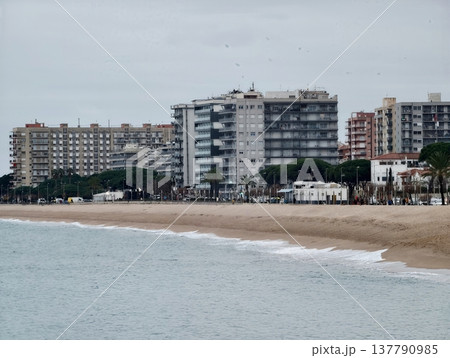 Relaxed Coastal Landscape With Apartment Complexes Along Calm Waters And Overcast Sky Reaching Distant Horizon Relaxed Coastal Landscape With Apartment Complexes Along Calm Waters And Overcast Sky Reaching Distant Horizon 137790985