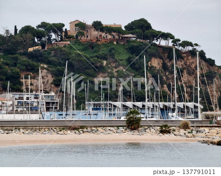 Serene Seaside View, Quiet Harbor With Sailing Vessels, Charming Waterfront Scene With Masts And Reflections 137791011