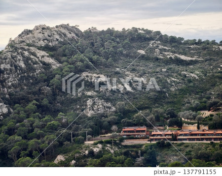 Terraced Houses Beside Rocky Slopes, Sunrise Shadows Cast Over Cliffside Homes Blending Into Rocks Terraced Houses Beside Rocky Slopes, Sunrise Shadows Cast Over Cliffside Homes Blending Into Rocks 137791155