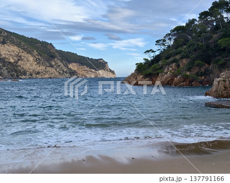 Serene Bay Nestled Among Rocky Cliffs, Quiet Seaside Refuge With Clear Waters And Rugged Formations 137791166
