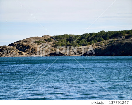 Peaceful Island With Scenic Views, Idyllic Rocky Outcrop Surrounded By Calm Sea And Distant Horizons Peaceful Island With Scenic Views, Idyllic Rocky Outcrop Surrounded By Calm Sea And Distant Horizons 137791247