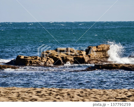 Rocky Coast With Lively Ocean Waves, Luminous Beachside View Featuring Rocks And Rolling Surf 137791259
