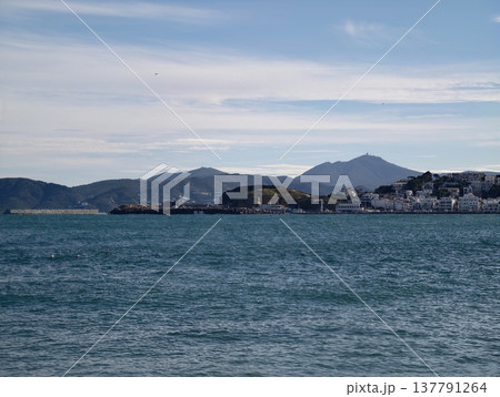 Tranquil Seaside With Mountain Shadows, Peaceful Shoreline Featuring Distant Mountain Shapes Softly Outlined 137791264