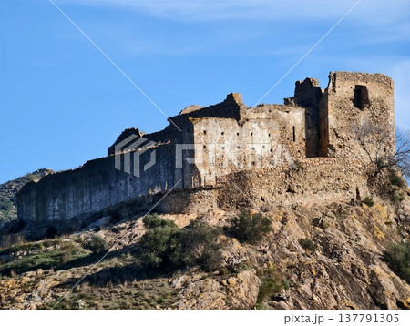 Historic Stone Structure With Moss And Sparse Plants Under Vivid Blue Sky For Exploring Landscape And History 137791305