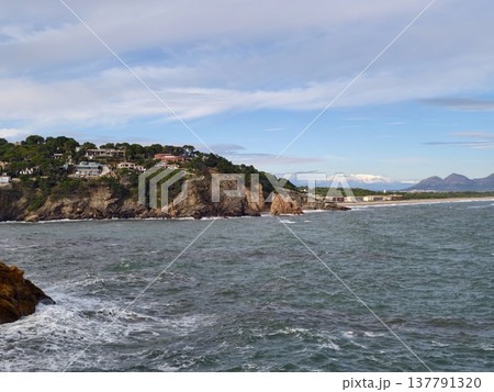Peaceful Coastal Landscape Scene, Quiet Cliffside Harbor Surrounded By Greenery And Gentle Surf 137791320