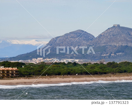 Idyllic Coastal Scene Showcasing Village At Mountain Base With Turquoise Waters And Natural Surroundings Idyllic Coastal Scene Showcasing Village At Mountain Base With Turquoise Waters And Natural Surroundings 137791323