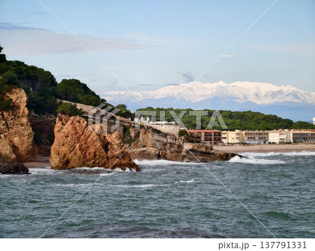Charming Hamlet Near Bright Blue Waters, Scenic Seashore Settlement With Snow Peaks And Rocky Cliffs 137791331