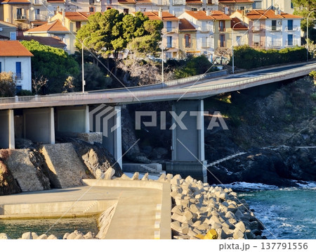 Coastal Cliffs With Vibrant Sunrise, Serene Dawn On Rocky Coast With Colorful Rooftops And Calm Blue Sea Coastal Cliffs With Vibrant Sunrise, Serene Dawn On Rocky Coast With Colorful Rooftops And Calm Blue Sea 137791556