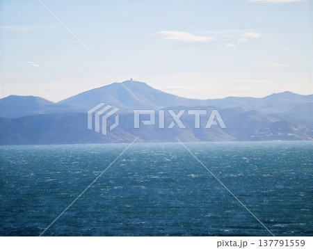 Tranquil Coastal Landscape For Relaxation, Peaceful Oceanfront With Mountains Under Bright Sky Tranquil Coastal Landscape For Relaxation, Peaceful Oceanfront With Mountains Under Bright Sky 137791559