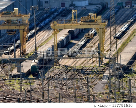 Loading Area With Cranes And Wagons, Large Industrial Site With Rail Equipment And Containers Loading Area With Cranes And Wagons, Large Industrial Site With Rail Equipment And Containers 137791610