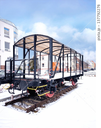 The frame of an old freight car on snowy tracks 137792276