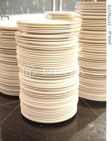 Huge stacks of white plates at a restaurant buffet or reception 137792278