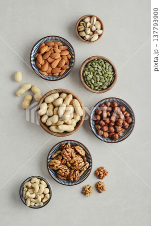 Walnuts, cashews, almonds, hazelnuts, peanuts, pistachios and pumpkin seeds in plates Walnuts, cashews, almonds, hazelnuts, peanuts, pistachios and pumpkin seeds in plates 137793900