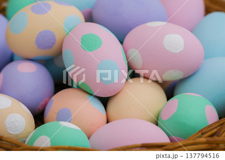many colorful pastel decorated easter eggs in small wooden basket many colorful pastel decorated easter eggs in small wooden basket 137794516
