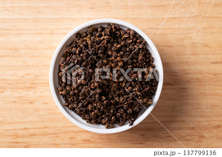 Northern Thai Sichuan Pepper (Makhwaen) in a bowl on wooden background, Table top view Northern Thai Sichuan Pepper (Makhwaen) in a bowl on wooden background, Table top view 137799136