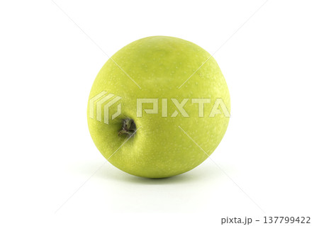 A single, ripe green apple with a smooth skin and a small stem, isolated on a white background 137799422
