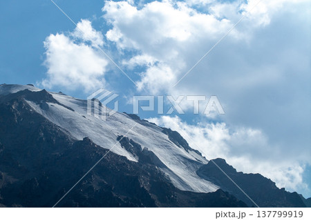Close view of the permanent snow and ice on the high altitude peaks of Zailiysky Alatau. 137799919