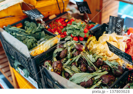 Fresh vegetables and fruits for sale at a local market in the morning hours 137803028