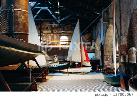 Boats inside a large building with wooden beams at a marina during the daytime Boats inside a large building with wooden beams at a marina during the daytime 137803067