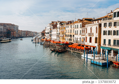 Canal in Venice with boats and colorful buildings during the day 137803072