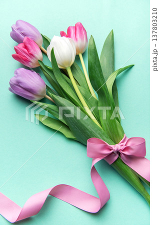 Tulips bouquet with pink ribbon on mint background 137803210