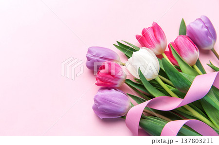 Colorful tulip flowers bouquet with pink ribbon on background 137803211