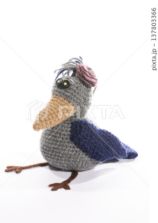 Knitted wool toy crow on a white background Knitted wool toy crow on a white background 137803366