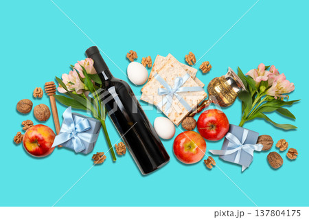 Passover items are arranged with flowers, wine, and matzah 137804175