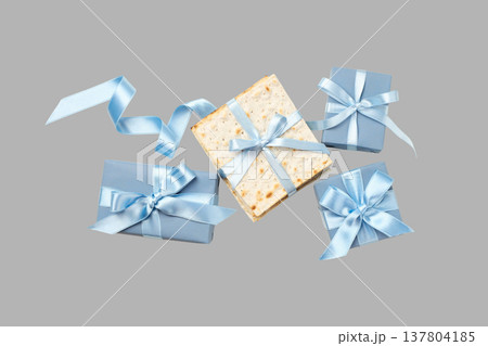 Matzah and wrapped gifts with ribbons arranged for Passover 137804185