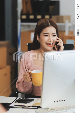 Starting small businesses SME owners female entrepreneurs check online orders to prepare to pack the boxes, sell to customers, sme business ideas online. Starting small businesses SME owners female entrepreneurs check online orders to prepare to pack the boxes, sell to customers, sme business ideas online. 137804257