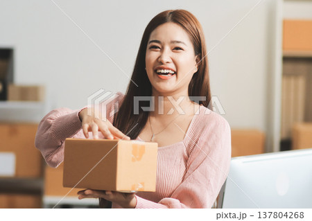 Starting small businesses SME owners female entrepreneurs check online orders to prepare to pack the boxes, sell to customers, sme business ideas online. 137804268