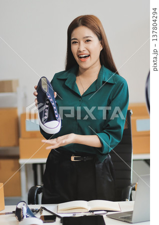 Starting small businesses SME owners female entrepreneurs check online orders to prepare to pack the boxes, sell to customers, sme business ideas online. 137804294