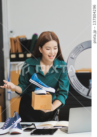 Starting small businesses SME owners female entrepreneurs check online orders to prepare to pack the boxes, sell to customers, sme business ideas online. Starting small businesses SME owners female entrepreneurs check online orders to prepare to pack the boxes, sell to customers, sme business ideas online. 137804296